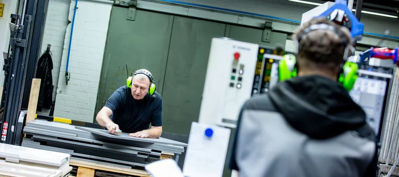 Zwei Mitarbeiter arbeiten an der CNC-Maschine vom Systemanbieter Siermeier & Niermann